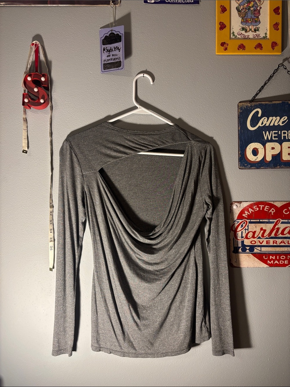 silver long sleeve with an asymmetrical open back